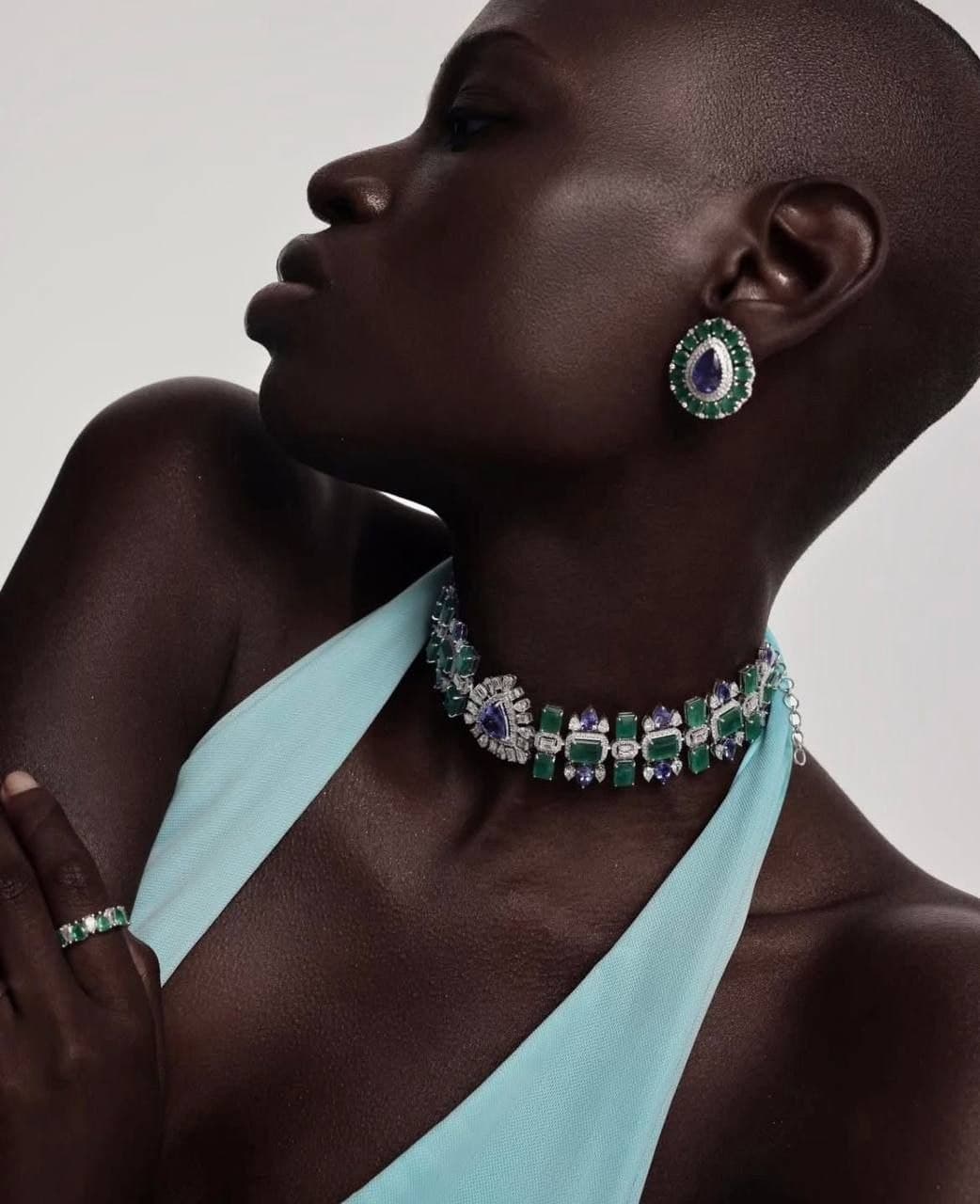Emerald and tanzanite choker on a velvet form